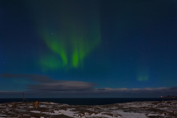 Obraz na płótnie Canvas The beautiful aurora borealis over the Arctic Ocean
