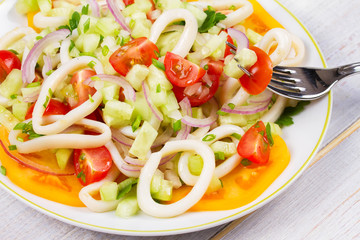 Squid, tomato, onion and greens salad