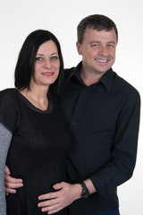 happy couple embracing on a white background
