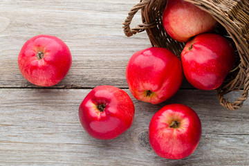 Ripe red apples on wooden background.