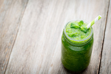 Rucola smoothie, on the grey  background.