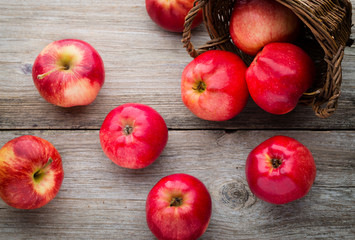 Ripe red apples on wooden background.