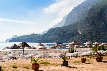 Deck chairs under thatched umbrellas on the beach of &Ccedil;ıralı.