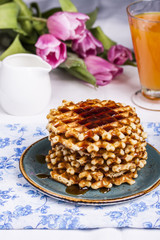 Fresh waffles with maple syrup and coffee