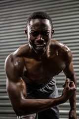 Obraz na płótnie Canvas Shirtless man showing biceps 