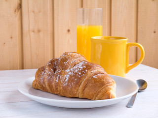 croissant,coffee and orange juice on the white wooden table