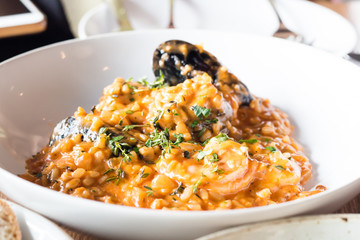 Seafood risotto on white plate
