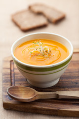 Pumpkin soup from carrots, 2 potatoes and Hokkaido pumpkin decorated with sprouts plus a slice of bread