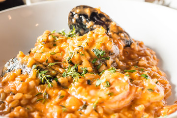 Seafood risotto on white plate
