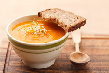 Pumpkin soup from carrots, 2 potatoes and Hokkaido pumpkin decorated with sprouts plus a slice of bread