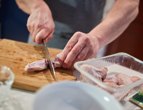 Man chopping chicken wings