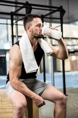 Muscular man drinking protein shake