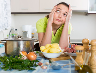 Confused housewife at kitchen
