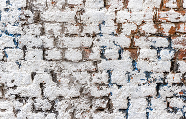 Old weathered white brick wall as background