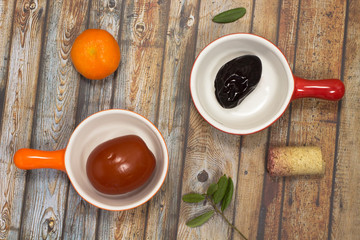 Pickled plum in the red plate. Pickled tomatoes in orange plate.