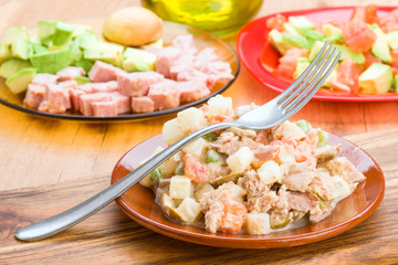 Russian salad in clay dish