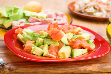 chopped avocado and diced tomato on plate