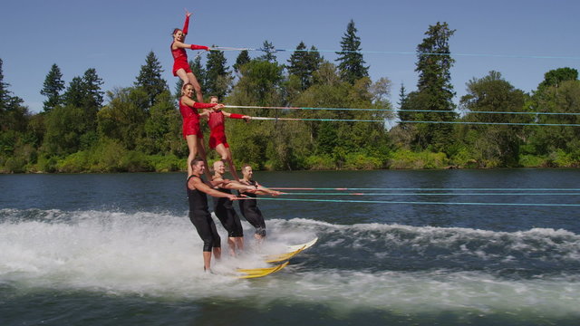Stunt water skiers form human pyramid