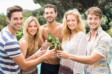 Group of friends toasting their beer bottles