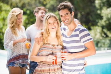 Young couple smiling and having juice together