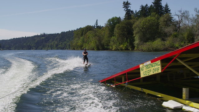 Water skier crashes off ski jump, slow motion