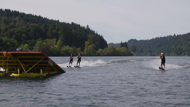 Water skiers go off jump