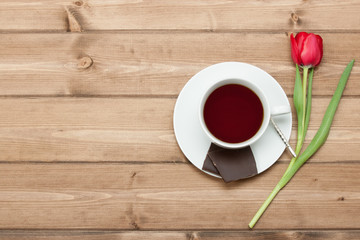 Tea Cup, Tulip Flower, Chocolate. Wooden Table. Top View. Copy S