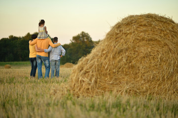 Naklejka na ściany i meble Happy family in wheat field