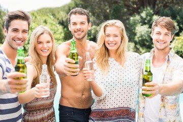 Group of friends showing their beer bottles