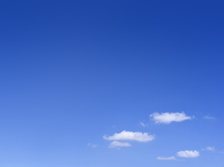 Blue sky with white cumulus clouds. Cloudscape in the sun, good weather with copy space. Nature background with clear blue sky and fluffy clouds.