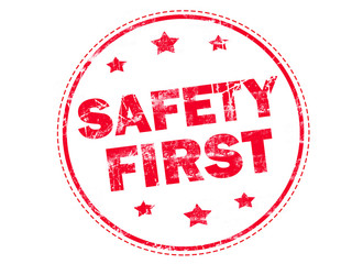 SAFETY FIRST on red grunge rubber stamp