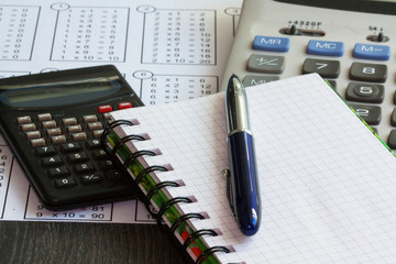 Calculatrices, table de multiplication, stylo et carnet