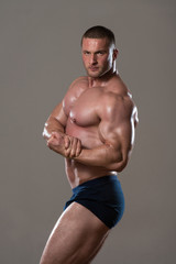 Muscular Man Flexing Muscles