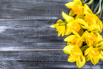 Yellow daffodils bouquet selected on wooden background