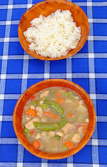 Chinese delicate sauce with beans, carrots, meat in a wooden bowl