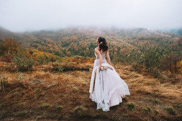 Fototapeta na wymiar Beautiful bride posing in high mountain scenery