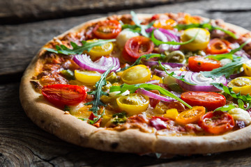 Pizza with arugula and cherry tomatoes