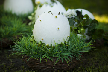wicker basket with white large decorative egg.