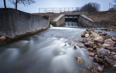 Long exposure photo of dam on river.