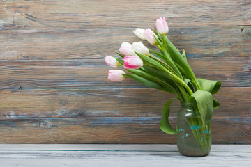 Colorful tulips flowers on wooden table. Top view with copy space