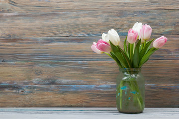 Colorful tulips flowers on wooden table. Top view with copy space
