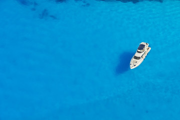 Aerial view of single yacht in azure sea