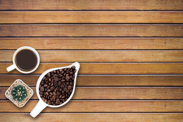 Coffee beans on wood texture background