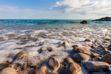 Fototapeta na wymiar Sea foam on stony beach