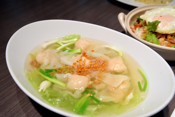 Chinese style wonton soup in white bowl