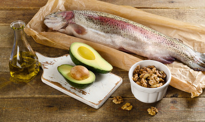 Foods Highest in unsaturated Fat on a rustic wooden background.