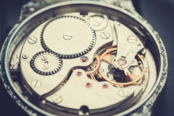 Fototapeta na wymiar mechanism antique vintage wrist watch beautiful original black and metallic background