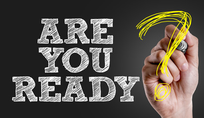 Hand writing the text: Are You Ready?