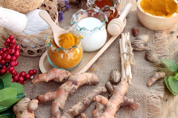 Turmeric powder with honey and milk for scrub.