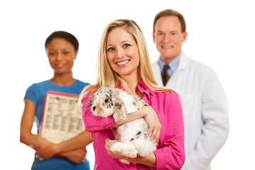 Veterinarian: Customer Holds Rabbit with Vet Behind